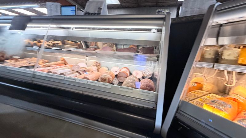 Salami Hangs Behind Glass Like Edible Artwork