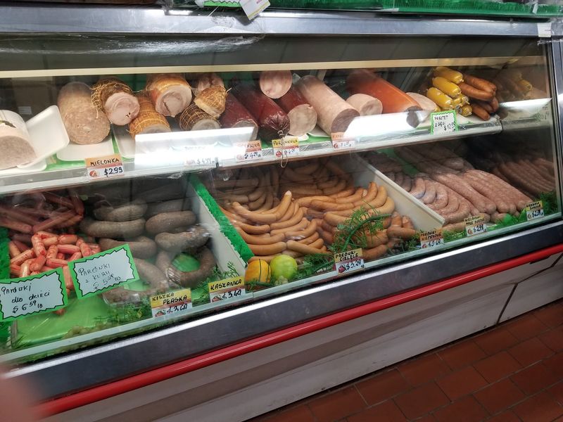 Over 20 Smoked Sausages Waiting Behind The Glass