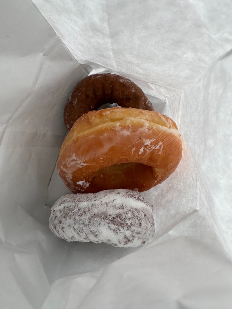 Glazed, Jelly, And Blueberry Donuts Fill The Case