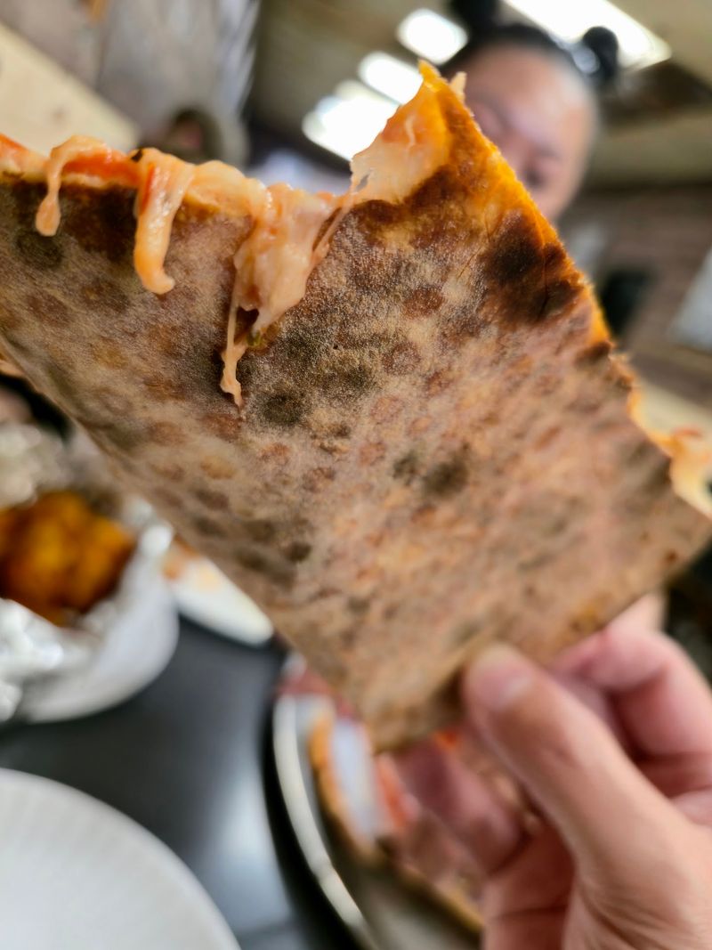 Thin, Foldable Crust Tossed In Plain Sight